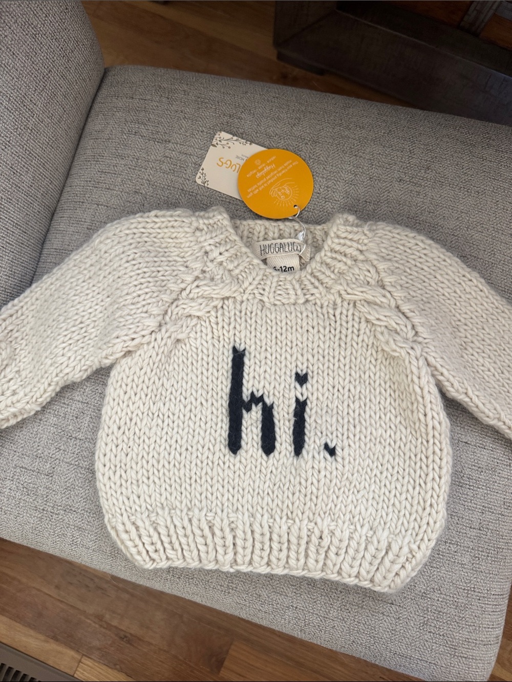 Huggabug Cream Knit Baby Sweater with black “hi.'